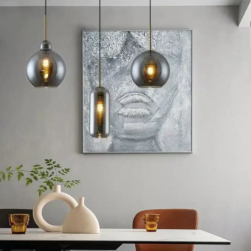 Modern gold mesh glass ball pendant light featuring spherical and cylindrical glass shades for kitchen dining decorbites pendant light