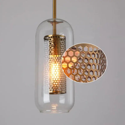 Modern gold mesh glass pendant light featuring a brass honeycomb cylinder and clear glass dome with warm bulb decorbites gold mesh