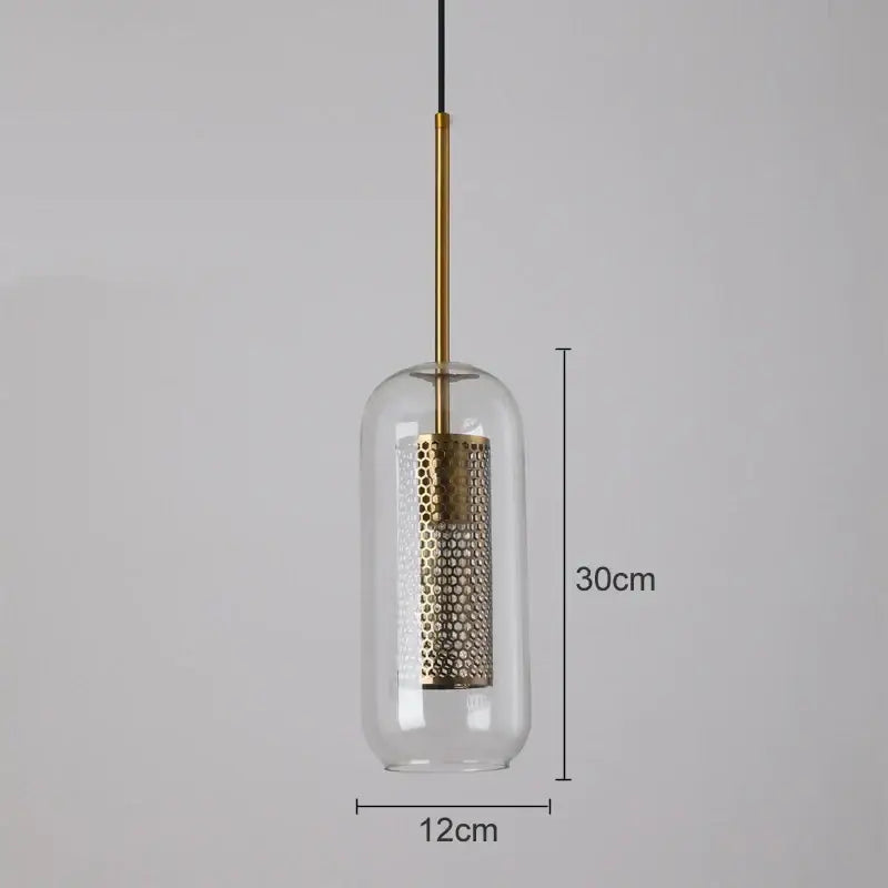 A modern pendant light with a clear glass dome and gold mesh glass perforated shade by decorbites gold mesh