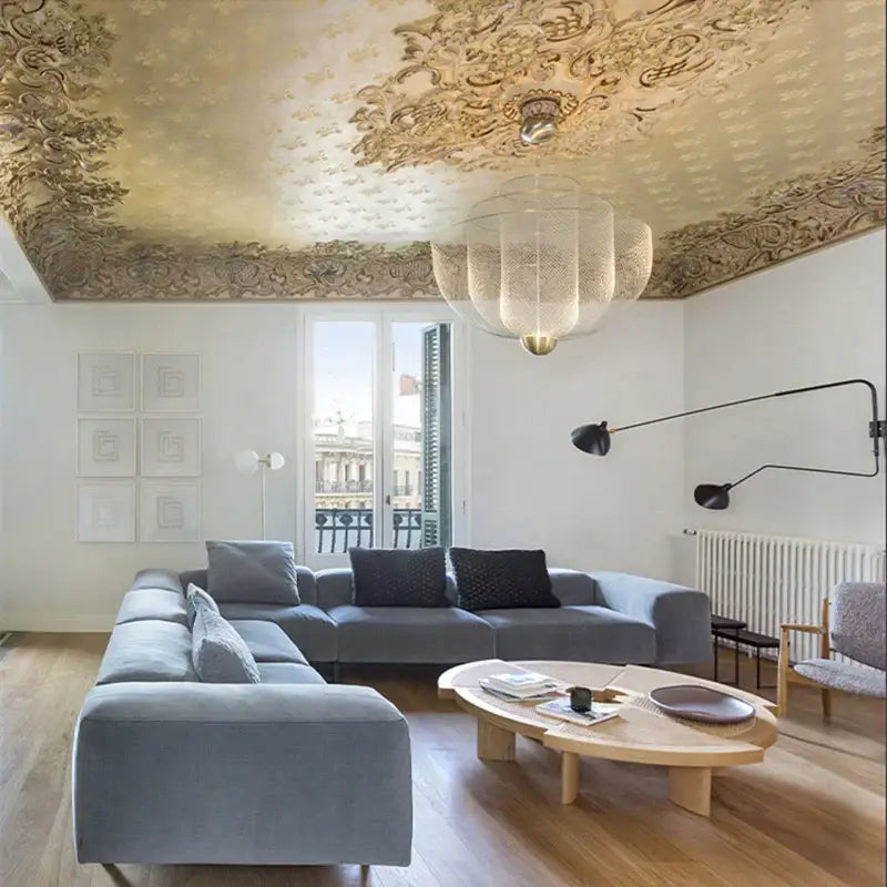 Gray velvet sectional sofa with plush cushions under a modern decorbites gold mesh grid ceiling chandelier dining room led light