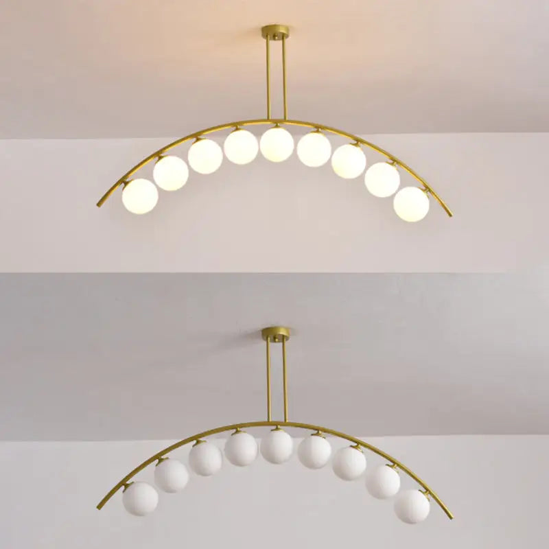 Modern gold metal arched ceiling light with ten frosted glass globe bulbs for dining room illumination