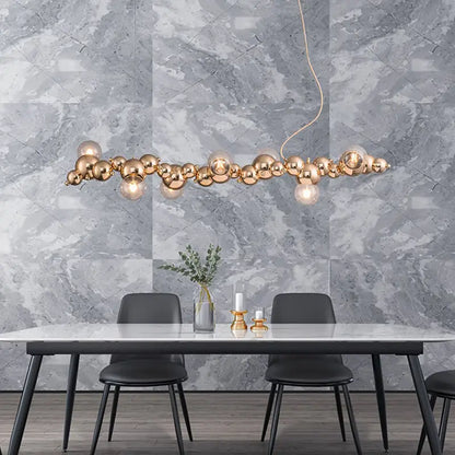 Gold metal spherical pendant ceiling light with modern clustered design for dining room featuring six bulbs