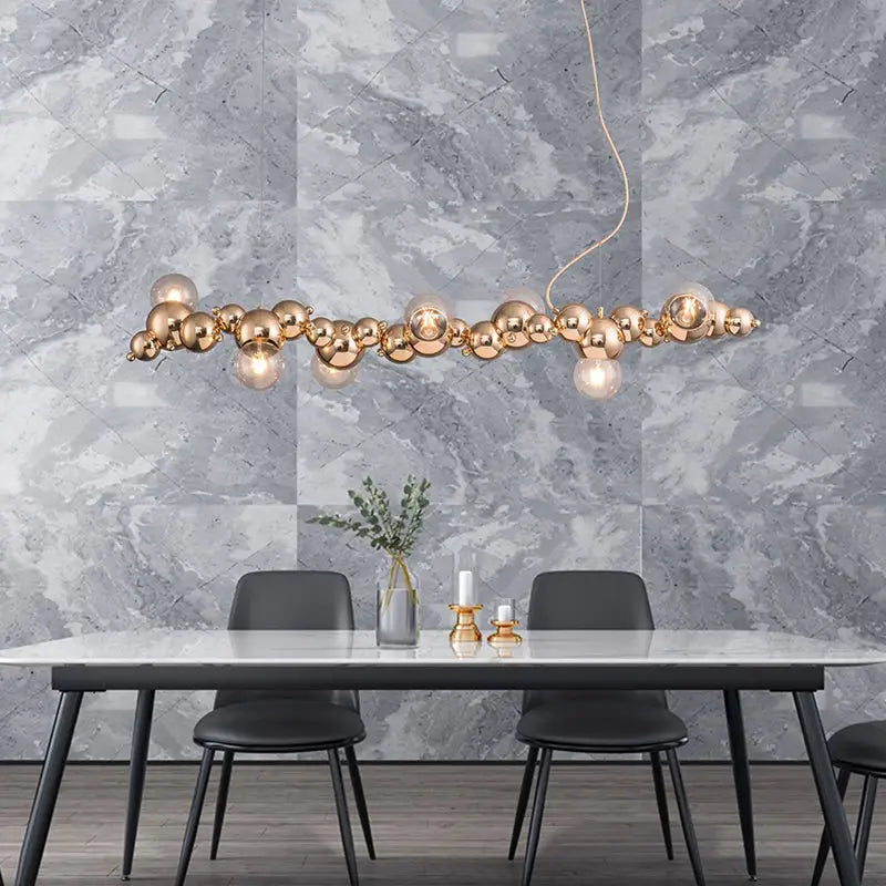 Gold metal spherical pendant ceiling light with modern clustered design for dining room featuring six bulbs