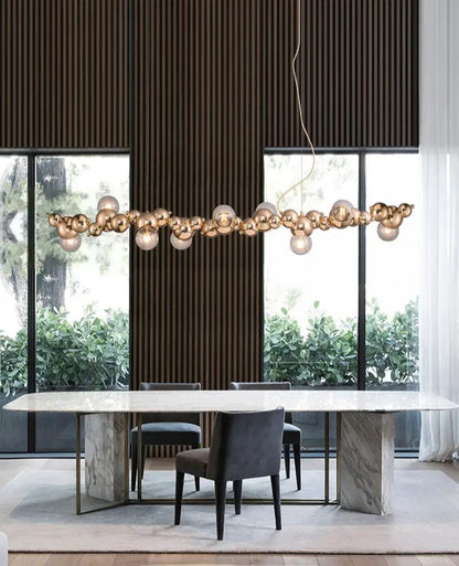 Modern gold metal arched ceiling light with six spherical glass bulbs for dining room illumination