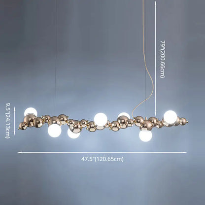 A modern gold metal arched ceiling light with six bulbs featuring polished brass spheres for dining room use