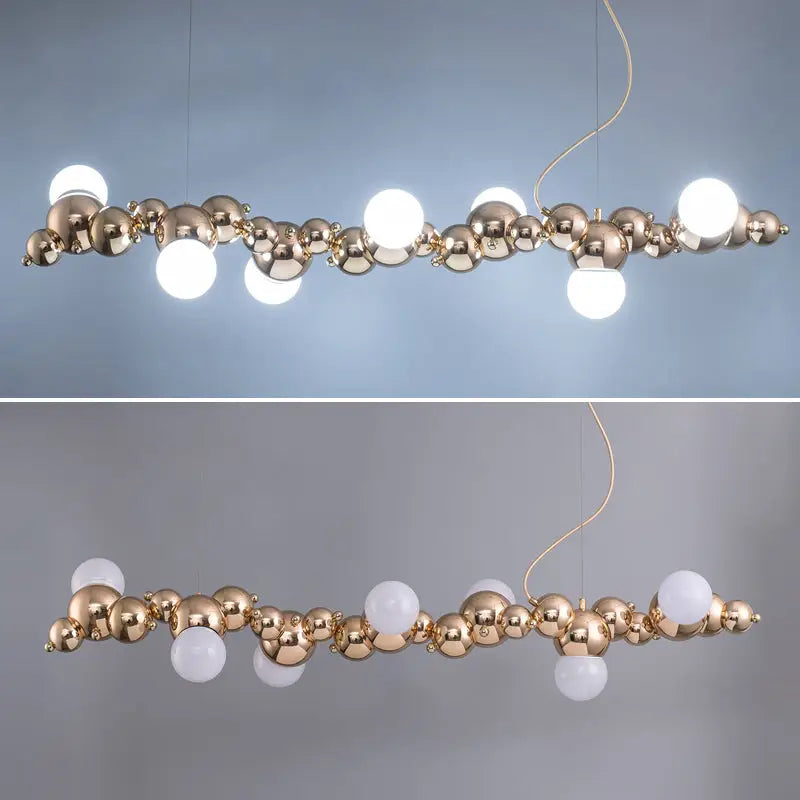 Modern gold metal ceiling light with six frosted glass and polished spheres for dining room use
