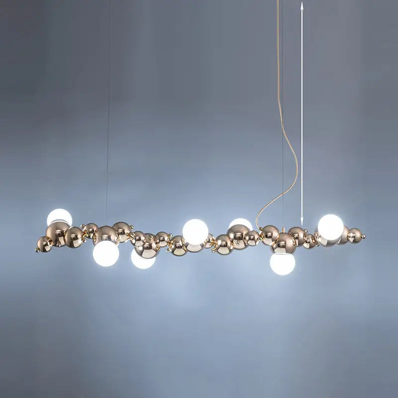 Modern gold metal arched ceiling light with six polished brass spheres and bulbs for dining room use