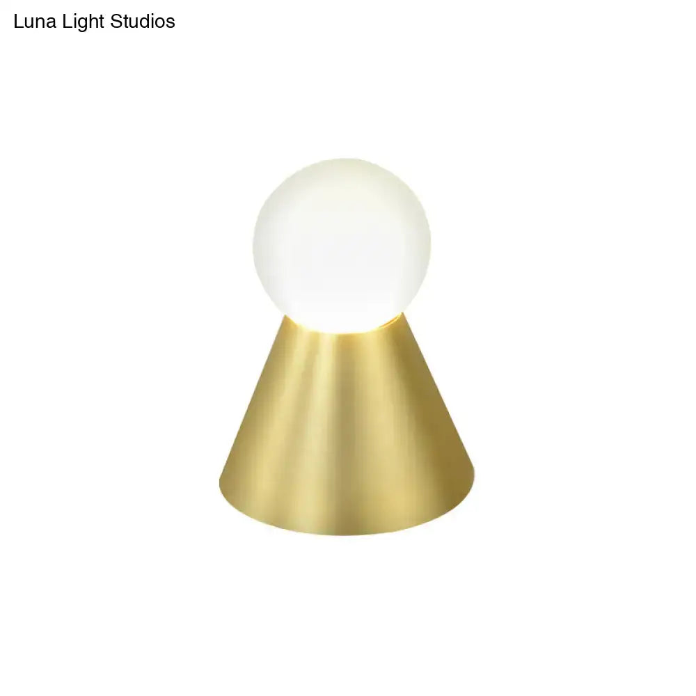 Modern gold metal conical sconce wall light with frosted globe and polished brass base for bedroom use