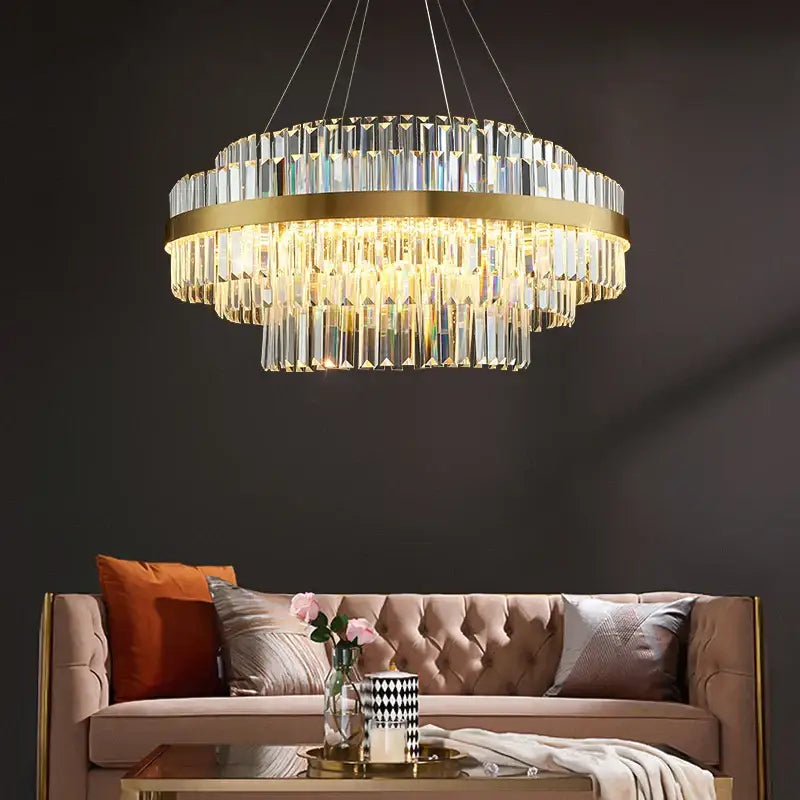 Modern gold metal crystal pendant light with cascading crystal prisms designed for dining room dimmable decorbites gold metal