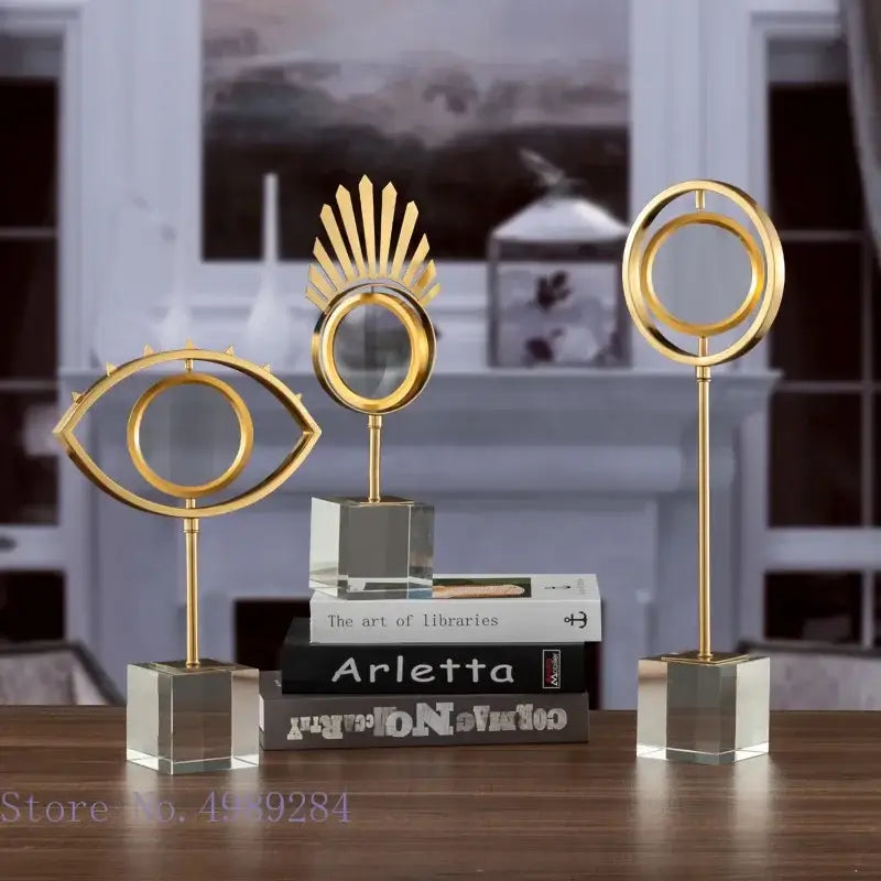 Three elegant gold metal magnifying glass sculptures with mirrored centers on clear acrylic glass base decorbites golden metal decor