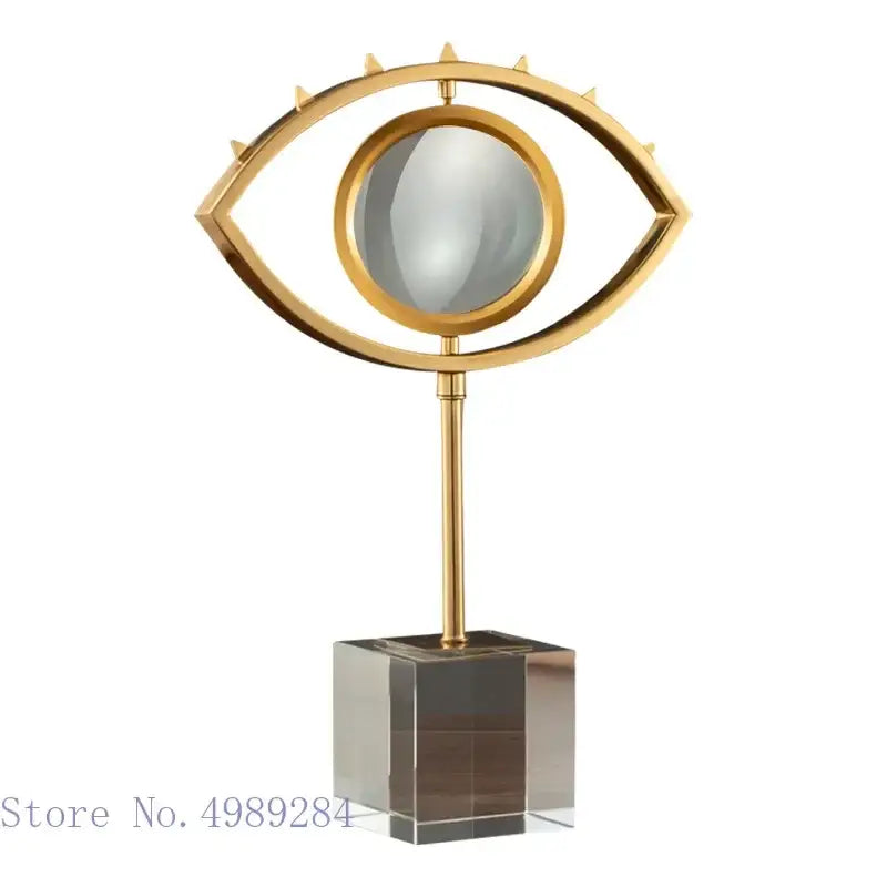 Modern gold metal eye magnifying glass with reflective lens on glass base by decorbites golden metal for living room decor