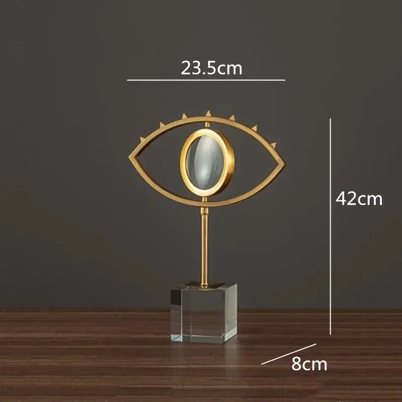 Modern gold metal magnifying glass with a spiked eye shape and glass base decorbites golden metal living room decor