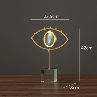 Modern gold metal magnifying glass with a spiked eye shape and glass base decorbites golden metal living room decor