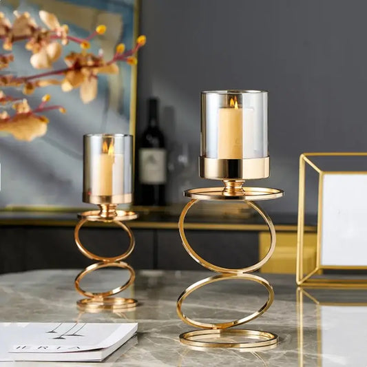 Modern gold metal frame glass candle holder with clear cylinders and lit white candles for dining room decorbites gold metal