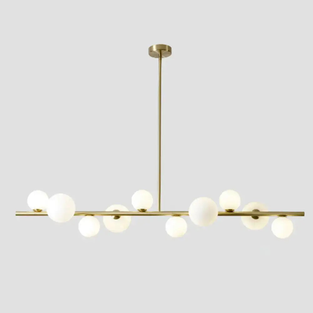 Modern gold metal glass globe chandelier with frosted bulbs and adjustable chain cord length for dining table lighting