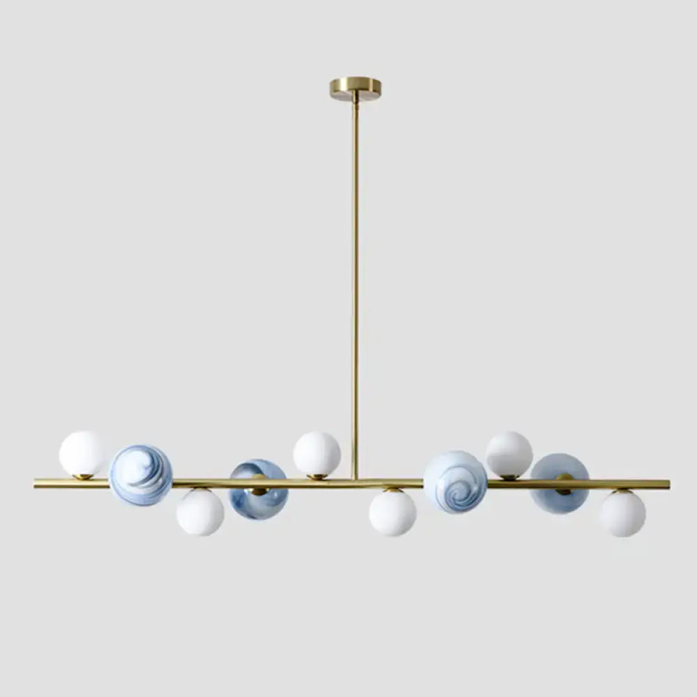 Modern gold metal glass globe chandelier with white and blue marbled lights and adjustable chain cord length for dining table
