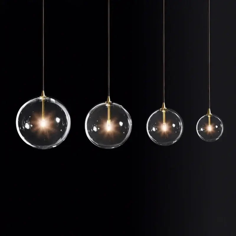 Four clear glass globe pendant lights with brass accents from decorbites gold metal globe pendant light collection