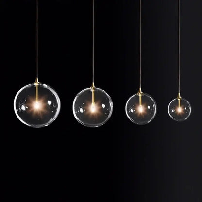 Four clear glass globe pendant lights with brass accents from decorbites gold metal globe pendant light collection