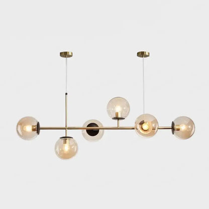 Modern gold metal island pendant with five blue glass spheres and minimalist design for dining room lighting