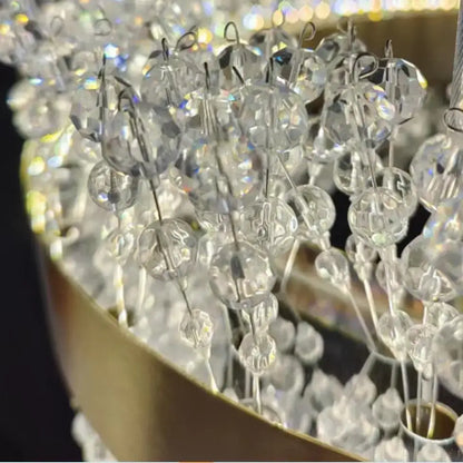 Modern gold metal led chandelier featuring crystal clear glass beads and metallic hooks for elegant dining room decorbites gold metal