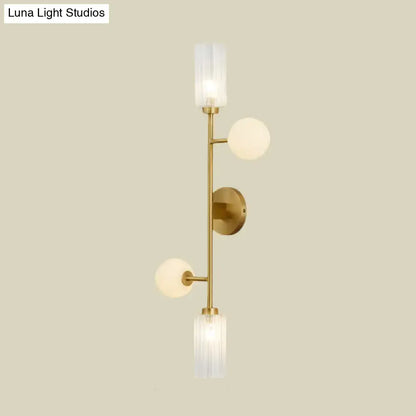 Modern gold metal pencil arm wall lamp with three illuminated frosted glass shades for bedroom lighting