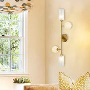 Modern gold metal pencil arm wall lamp with three frosted glass shades for bedroom lighting with metal pencil arm design