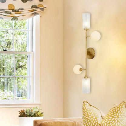 Modern gold metal pencil arm wall lamp with three frosted glass shades for bedroom lighting with metal pencil arm design
