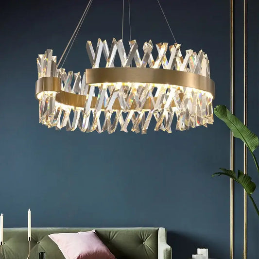 A modern pendant lamp with a gold metal frame and clear crystal prisms from decorbites shape lustre led collection
