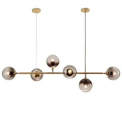 Modern gold metal pendant lighting featuring brass and smoked glass spherical bulbs for dining room use