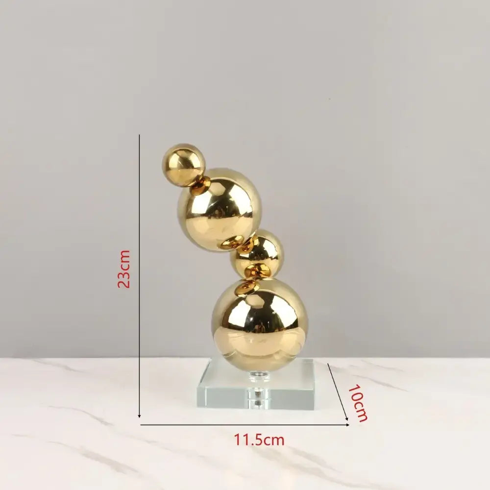 Modern gold metal spheres stacked art pieces featuring reflective golden metal spheres on a clear acrylic base decorbites gold metal
