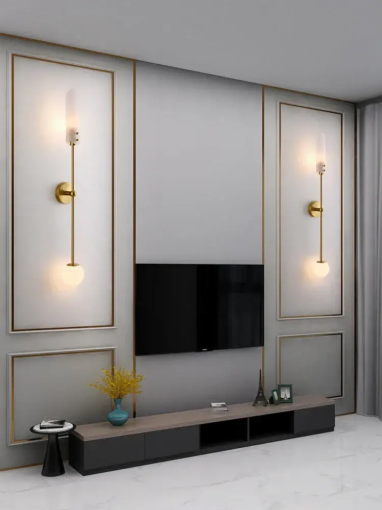 Modern gold metal wall light featuring slender vertical rods and frosted globe shades for bedroom decorbites gold metal sconce
