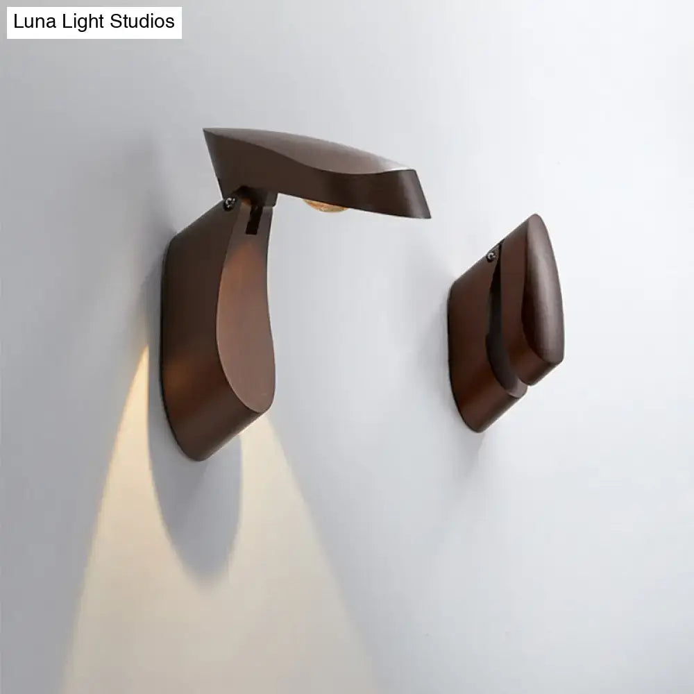 Modern bronze-finished metal wall light with sleek sculptural design for bedroom bedside fixture