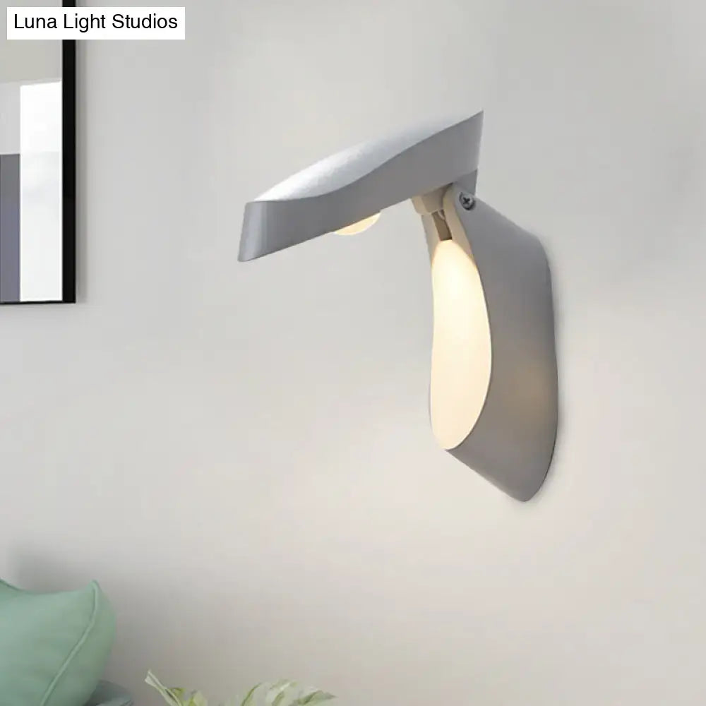 Modern gold metal wall light bedside fixture with sleek angular gray wall sconce and warm ambient lighting