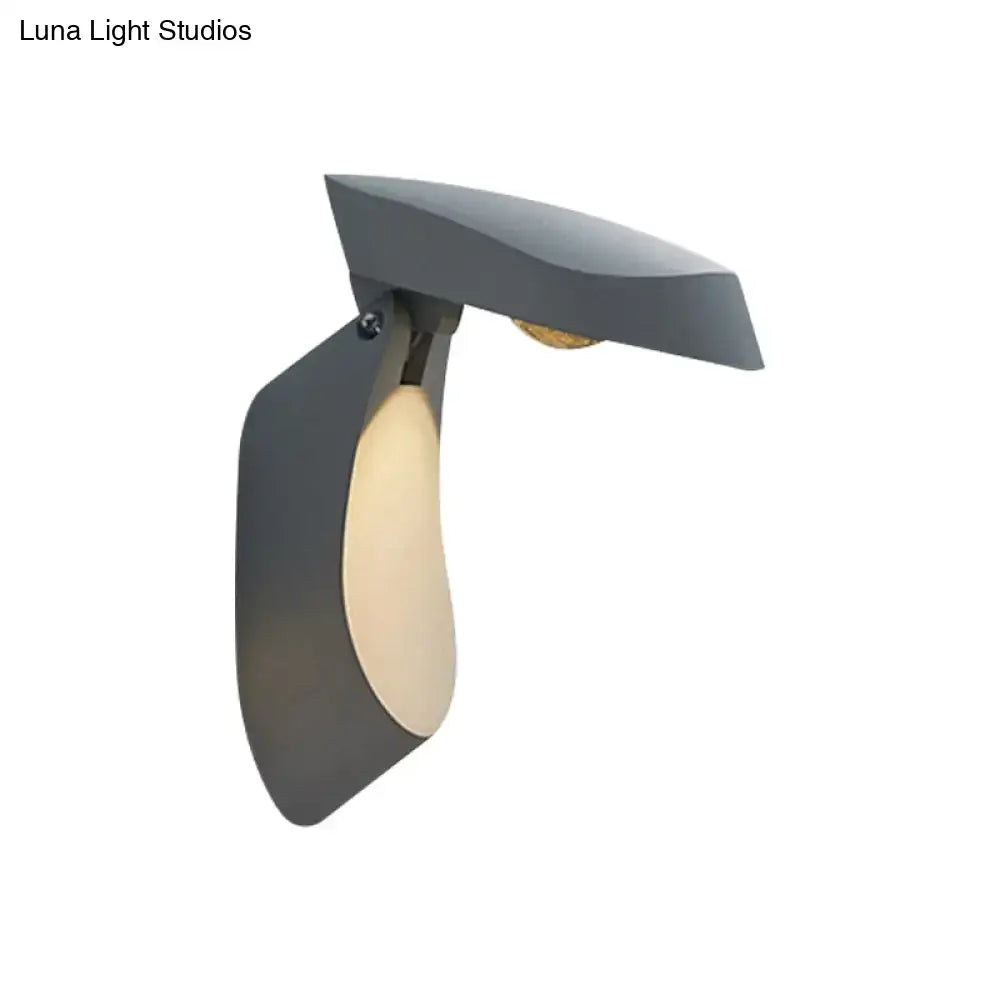 Modern gold metal wall light bedside fixture with a matte gray angular wall sconce and warm translucent oval panel