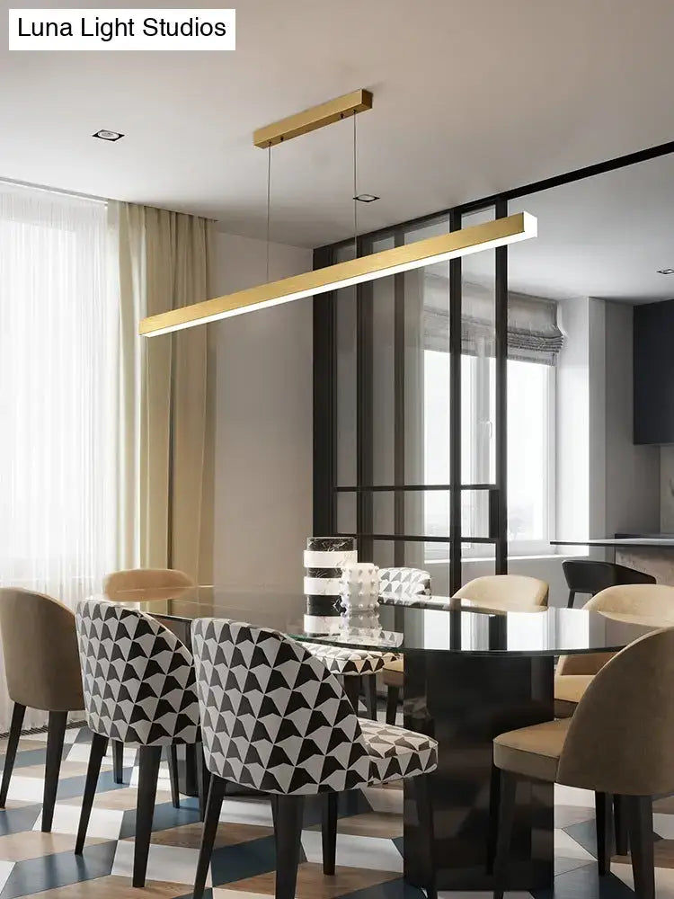 Modern gold minimalist led suspension lamp metal light fixture with linear design hanging above dining table