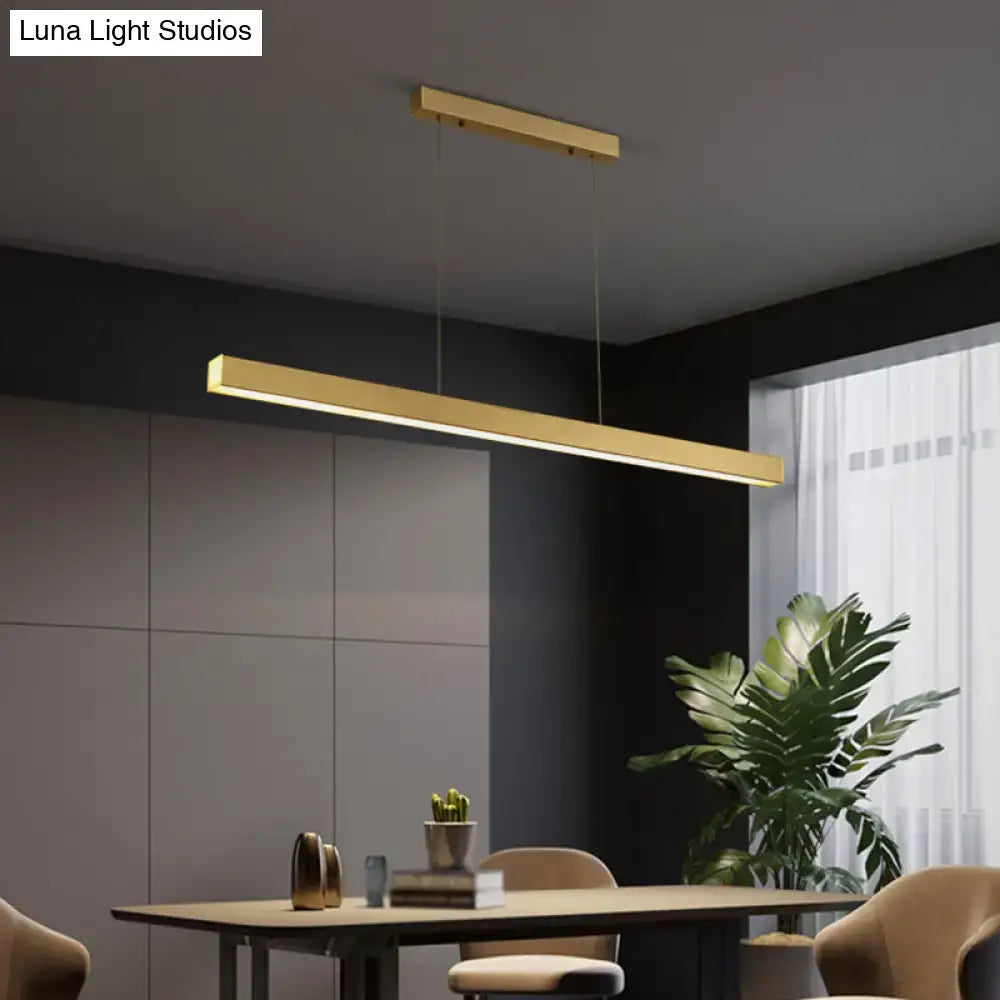 Modern gold minimalist led suspension lamp featuring a rectangular metal light fixture above a dining table