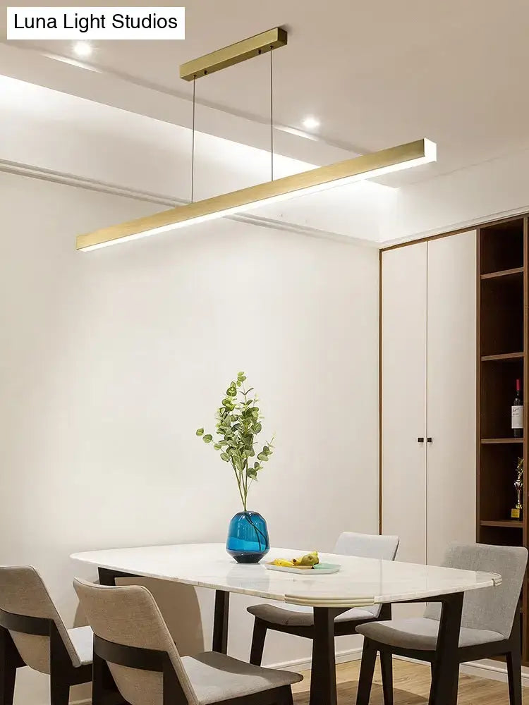 Modern gold minimalist led suspension lamp with metal linear design hanging above dining table light fixture