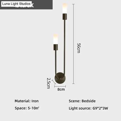 Modern black iron wall lamp with two upward-facing candle-style lights suitable as a led wall lamp