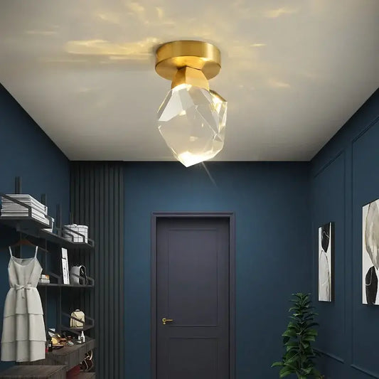 Modern gold minimalist led wall lamp with a gold-finished base and crystal globe emitting warm light for living room decorbites gold minimalist