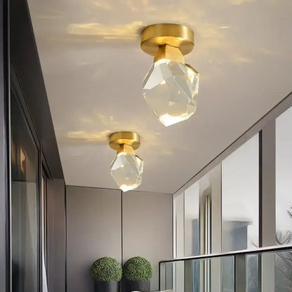 Modern gold minimalist led wall lamp featuring gold-finished ceiling-mounted fixtures with crystal-clear glass shades