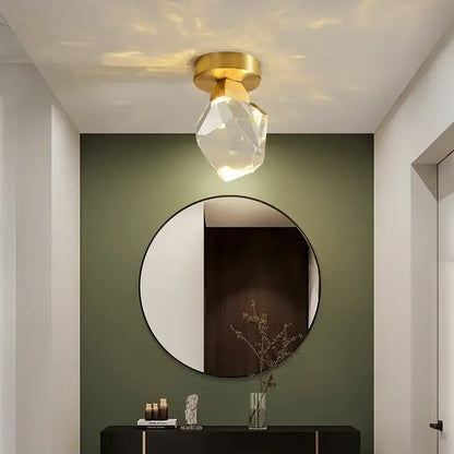 A modern gold minimalist led wall lamp with a gold-finished base and clear crystal globe for living room decorbites gold minimalist