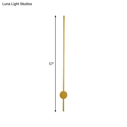 A sleek 57 inch tall brass wall light with minimalist design and fixture height ideal for modern bedroom lighting