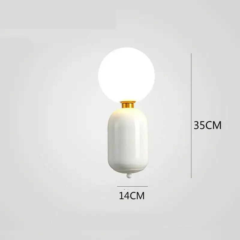 A sleek white ceramic wall lamp with gold-toned decorbites gold mirror accent and frosted glass globe sconce
