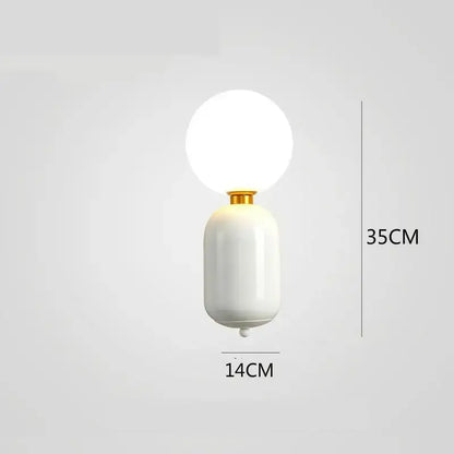 A sleek white ceramic wall lamp with gold-toned decorbites gold mirror accent and frosted glass globe sconce