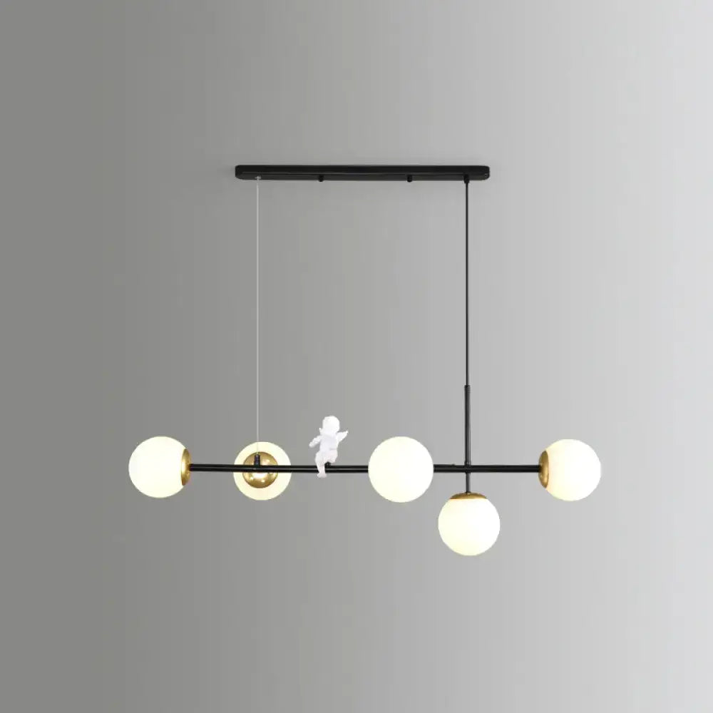 DecorBites™ Modo Island 5-light pendant light in gold black with milk white frosted glass globes for restaurants