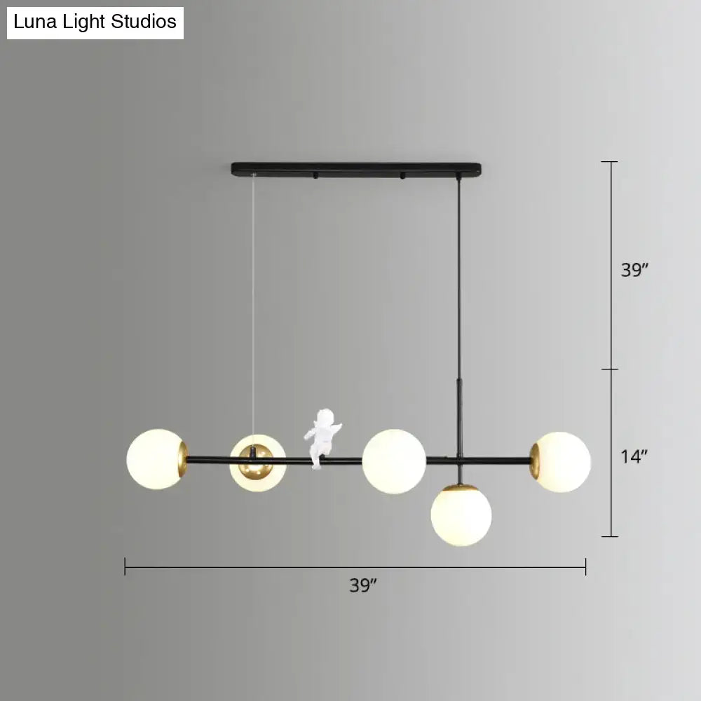 Modern black metal modo island chandelier with four milk white frosted glass globes and gold black accents for restaurants