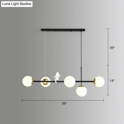 Modern black metal modo island chandelier with four milk white frosted glass globes and gold black accents for restaurants
