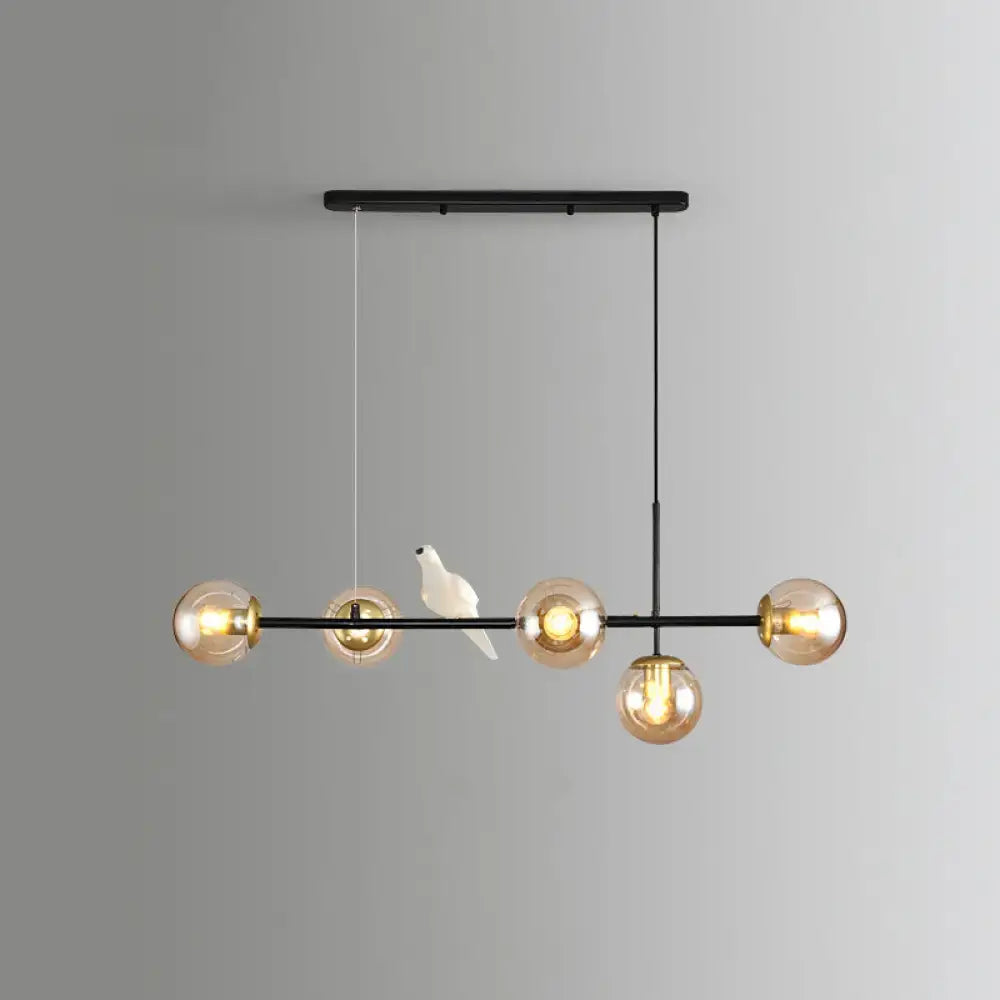 Decorbites modo island black metal chandelier with five amber glass globes and milk white ceramic bird for restaurants