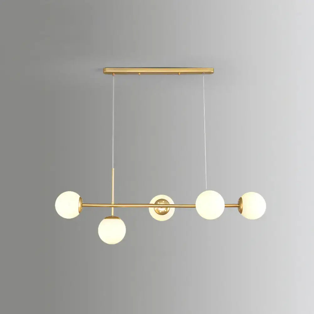 Decorbites modo island 5-light pendant light features modern gold-toned metal with milk white frosted glass globes for restaurants