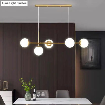 Decorbites modo island 5-light pendant light with gold-toned metal and milk white glass bulbs for restaurants